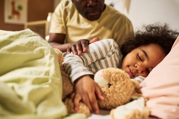 Healthy Sleep Habits for Kids, Bedtime routine for kids, dad helping child fall asleep