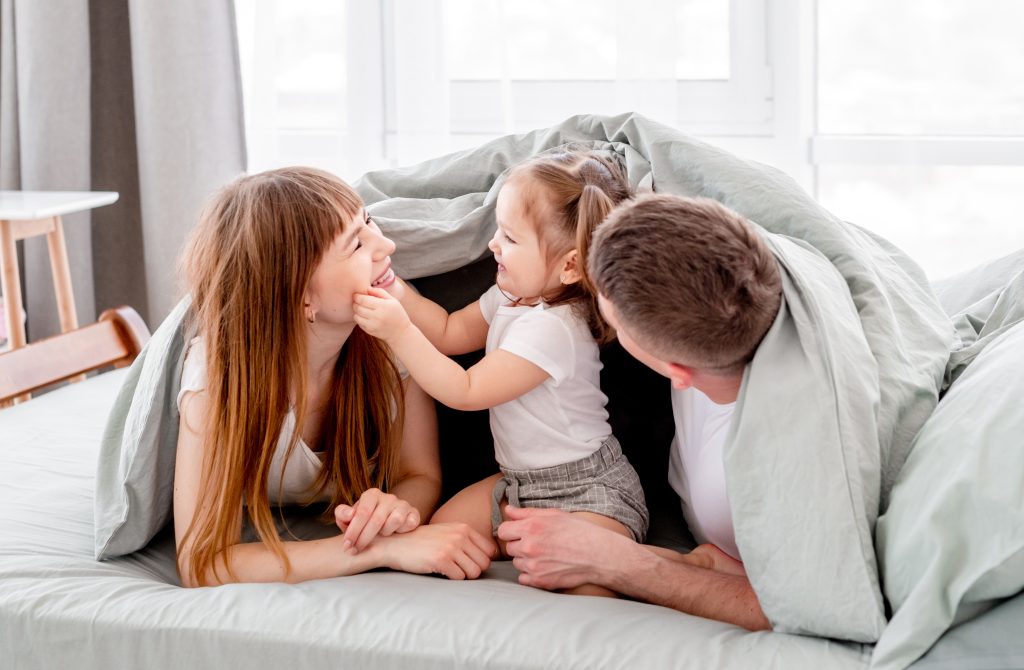 Family under the blanket in the bed - SKIDamarink KIDs