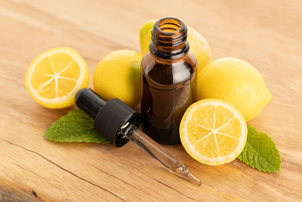 Lemon essential oil on wooden table - SKIDamarink KIDs