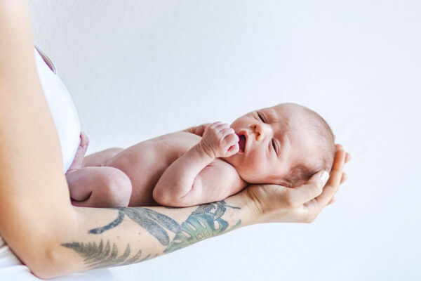 newborn-baby-in-mother-s-arms-2025-01-08-04-11-32-utc - SKIDamarink KIDs