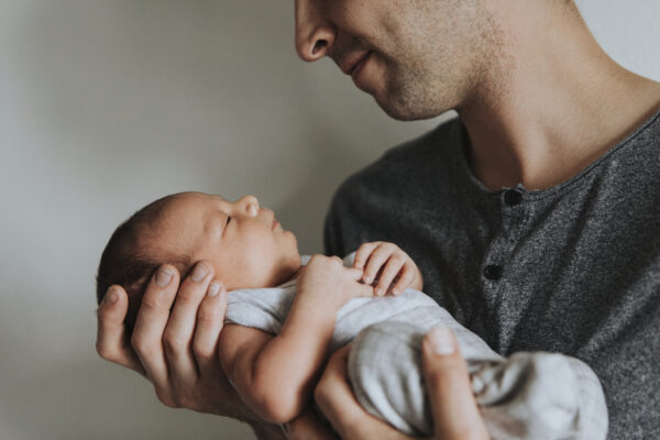 Young father holding his baby - SKIDamarink KIDs newborn care tips