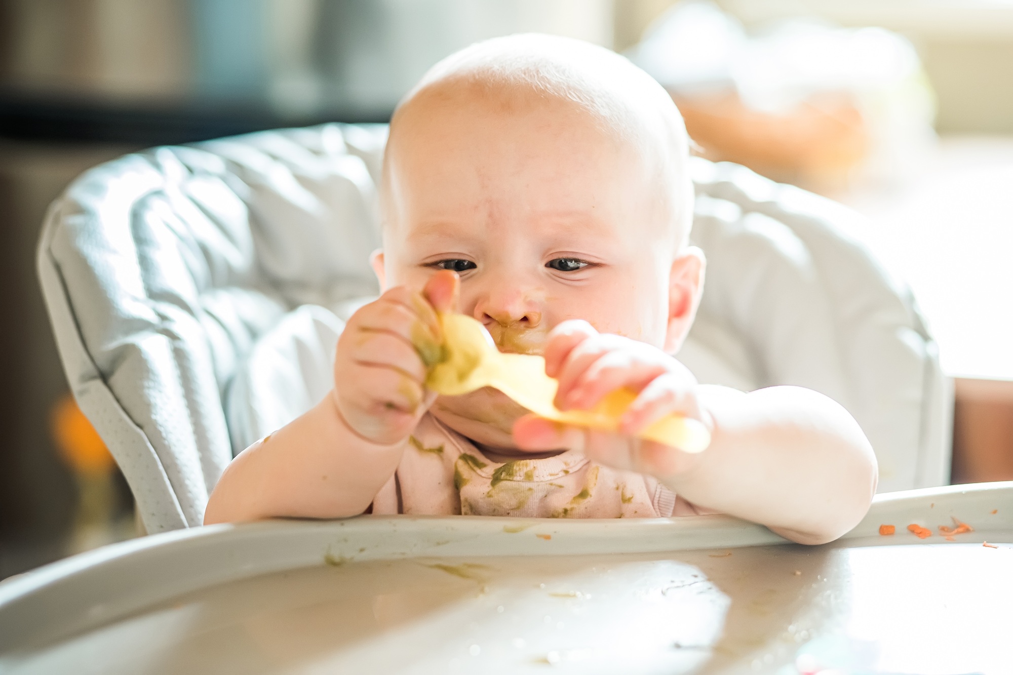 6 month Old Baby Girl At Home In High Chair eating tasty food at home Funny baby with soiled health - SKIDamarink KIDs 6 month Old Baby Girl At Home In High Chair eating tasty food at home. Funny baby with soiled health