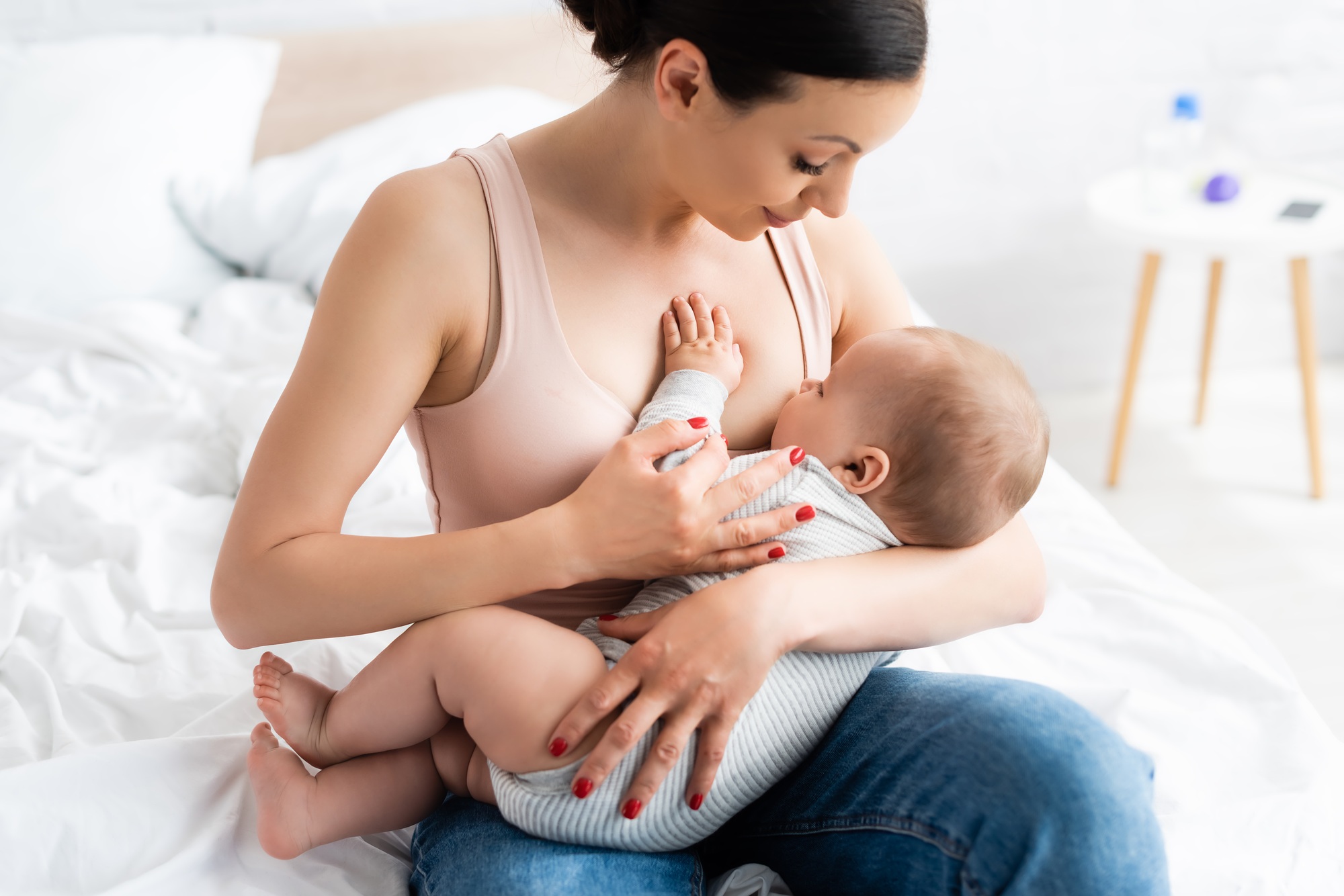 caring mother breastfeeding baby boy in bedroom - SKIDamarink KIDs caring mother breastfeeding baby boy in bedroom