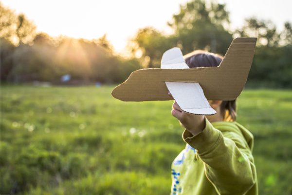 child plays outside the house at sunset with craft airplanes Active games with children - SKIDamarink KIDs child plays outside the house at sunset with craft airplanes. Active games with children