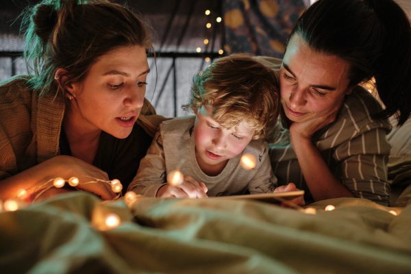 Family reading a book at night - SKIDamarink KIDs Family reading a book at night
