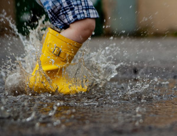 Little Boy Jumping in a Rain Puddle