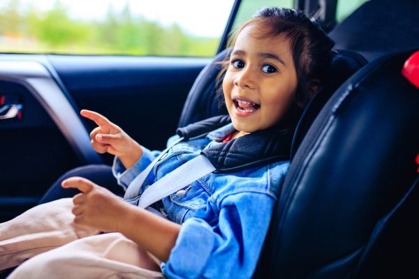mixed race baby girl in car seat with fastened belt - SKIDamarink KIDs mixed race baby girl in car seat with fastened belt