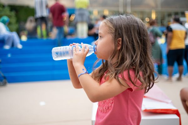 Child drink water from plastic bottle outdoor - SKIDamarink KIDs Child drink water from plastic bottle outdoor