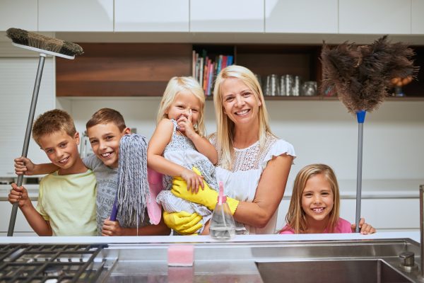 Portrait of a mother and her kids doing chores together at home - SKIDamarink KIDs teach-kids-to-clean
