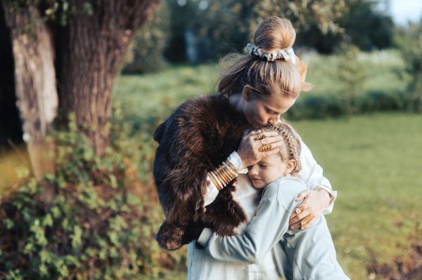 Young loving mother hugging her daughter mom demonstrating unconditional love for child - SKIDamarink KIDs Young loving mother hugging her daughter, mom demonstrating unconditional love for child