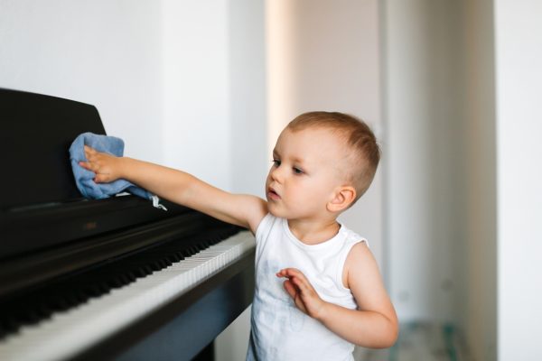 cute kid toddler dusting the piano toddler helping to clean the house care and helping mom - SKIDamarink KIDs cute kid toddler dusting the piano, toddler helping to clean the house, care and helping mom